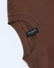 A brown unisex heavy cotton oversized tee with a round neckline and a tag visible on the inside seam.