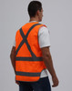 An orange Hi-Vis X Back Safety Vest with grey reflective stripes, displayed on a mannequin from the back.