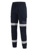 Cotton stretch drill cuffed work pants in navy with reflective tape detailing, featuring cargo pockets and an elastic waist.