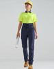A pair of navy work pants with a flexible fit, worn with a fluorescent yellow polo shirt and a hard hat.