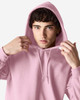 A model wearing a pink Gildan Heavy Blend Adult Hooded Sweatshirt with the hood up.