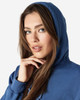 A blue hooded sweatshirt with a female model showcasing the product, featuring a logo on the fabric.