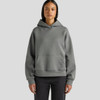 A hooded sweatshirt in a soft grey colour, featuring a front pocket and a relaxed fit.