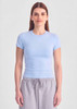 A light blue women's baby tee is displayed, featuring short sleeves and a fitted design.