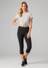 A model wears women's black 3/4 leggings paired with a grey knotted t-shirt. The leggings have a logo on the waistband.