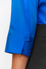 A vibrant blue 3/4 sleeve button-up shirt with a stylish cuff detail and a logo.