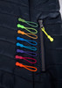 A collection of coloured zipper pulls arranged beside a zipper on a dark quilted garment. The pulls come in various vibrant hues.