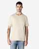 A light beige adult T-shirt displayed on a male model, featuring a crew neck and short sleeves.