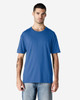 A man models a blue Gildan Softstyle adult t-shirt, paired with light denim jeans. The shirt has a logo.