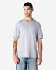 A model wears a grey Gildan Softstyle adult T-shirt featuring a relaxed fit and a crew neckline.