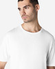 A white Gildan Softstyle adult T-shirt displayed on a model with a neutral background, featuring a logo.