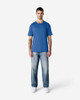 A blue Gildan Softstyle adult T-shirt displayed on a model wearing light blue jeans and white shoes.