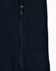 A dark navy softshell jacket featuring a zippered pocket and a sleek design. The jacket also has a logo.