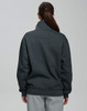 A dark grey 1/2 zip collar polar fleece jumper with a relaxed fit and a plain back. Features a branding logo.