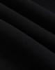 A close-up of black polar fleece fabric, showcasing its soft texture and layering. The image features a logo.
