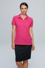 A woman in a bright pink polo shirt paired with a black skirt, featuring a logo on the shirt.