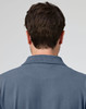 A men's cotton stretch polo shirt in a blue shade, featuring a collar and logo on the back.