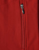 A close-up of a red softshell vest featuring a zippered pocket and a logo.
