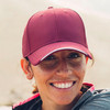 A maroon cap with a white visor and an adjustable back, featuring a logo on the front.