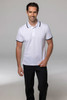 A smiling man wearing a white polo shirt with dark collar and sleeve trims, paired with black trousers.