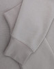 A light grey crewneck sweatshirt with a soft texture, featuring long sleeves and a cuffed hem.
