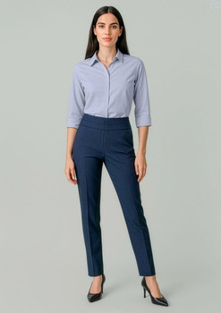 A pair of women's mid-waist slim leg pants in navy blue, featuring a sleek design. The model wears a light blue shirt and heels.