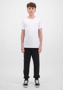 A pair of black track pants for youth, paired with a plain white t-shirt and black shoes.