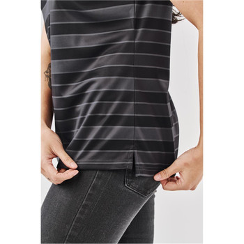 A close-up of a women's dark grey striped polo shirt being adjusted at the hem, with a slight side split visible.