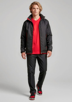 A model wears black track pants with a matching jacket and a red t-shirt, featuring a logo.