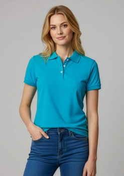 A woman wearing a vibrant teal short sleeve polo shirt, featuring a collar and buttons, paired with jeans.