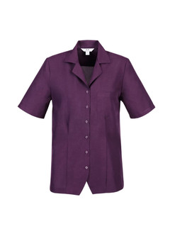 A short-sleeved overblouse in a rich purple colour with a button front and a pocket on the left chest.