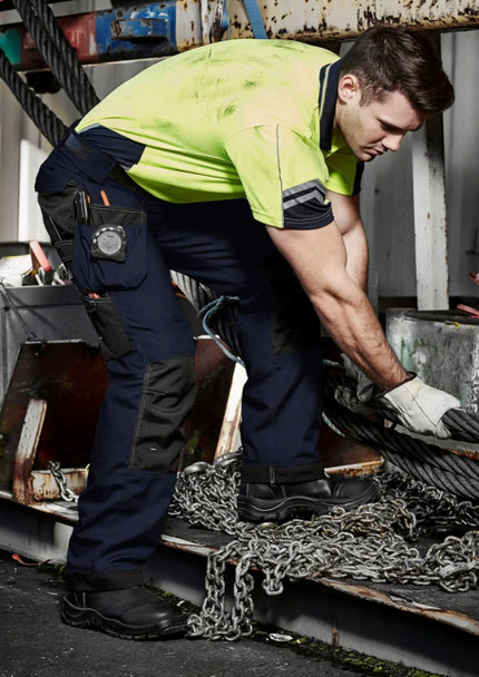 Men's ultralite multi-pocket pants in navy with multiple pockets, worn by a man in a high-visibility shirt.