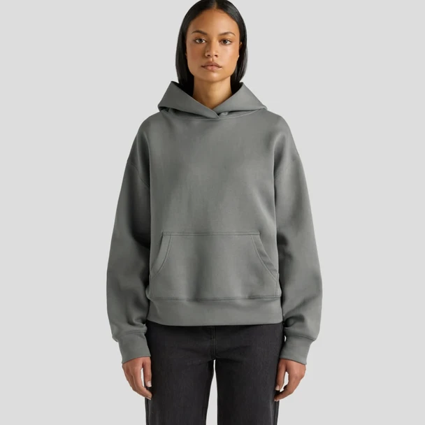 A hooded sweatshirt in a soft grey colour, featuring a front pocket and a relaxed fit.