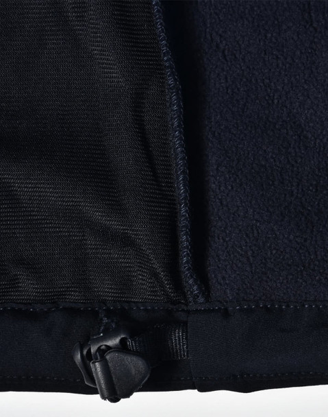 A close-up of a black ladies softshell jacket, highlighting the inner lining and adjustable hem detail.