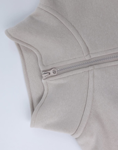 A grey 1/2 zip collar fleecy jumper with a smooth texture and a concealed zipper. Features a branding logo.