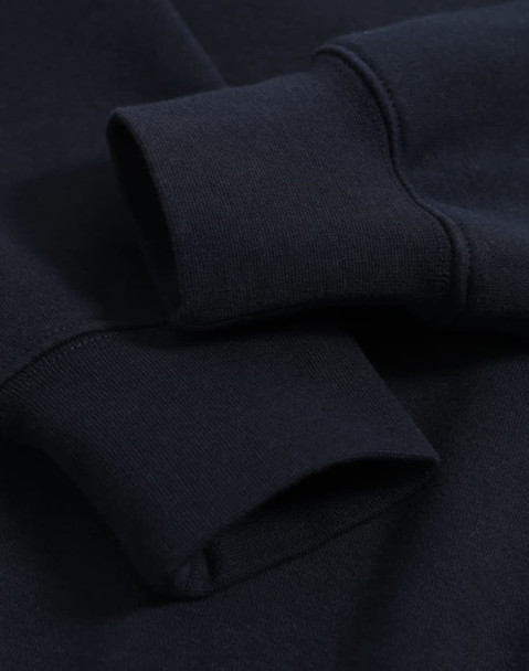 A close-up of a navy polar fleece jumper featuring half zip collar and ribbed cuffs with an unobtrusive logo.