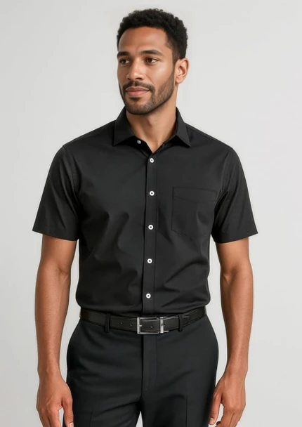 A short sleeve black button-up shirt with a pocket, worn by a man paired with dark trousers.
