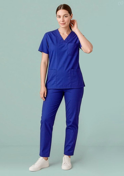 Unisex Hartwell reversible scrub pant in vibrant blue, featuring a relaxed fit and pockets, modelled by a woman.