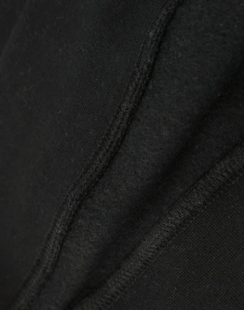 A close-up view of a black crew fleece sweat, highlighting its textured fabric and stitching details.