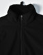 A black men's softshell high-tech jacket with a high collar and zip fastening, featuring a logo.