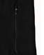 A close-up of a black softshell jacket featuring a zipped pocket and a branded logo.