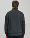 A grey 1/2 zip collar fleecy jumper with a relaxed fit, featuring a branded logo on the back.