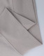 A close-up of a light beige polar fleece jumper featuring a half-zip collar. It has a simple design with a logo.