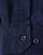A close-up of a blue long-sleeve shirt featuring segmented tape, with a buttoned cuff detail.