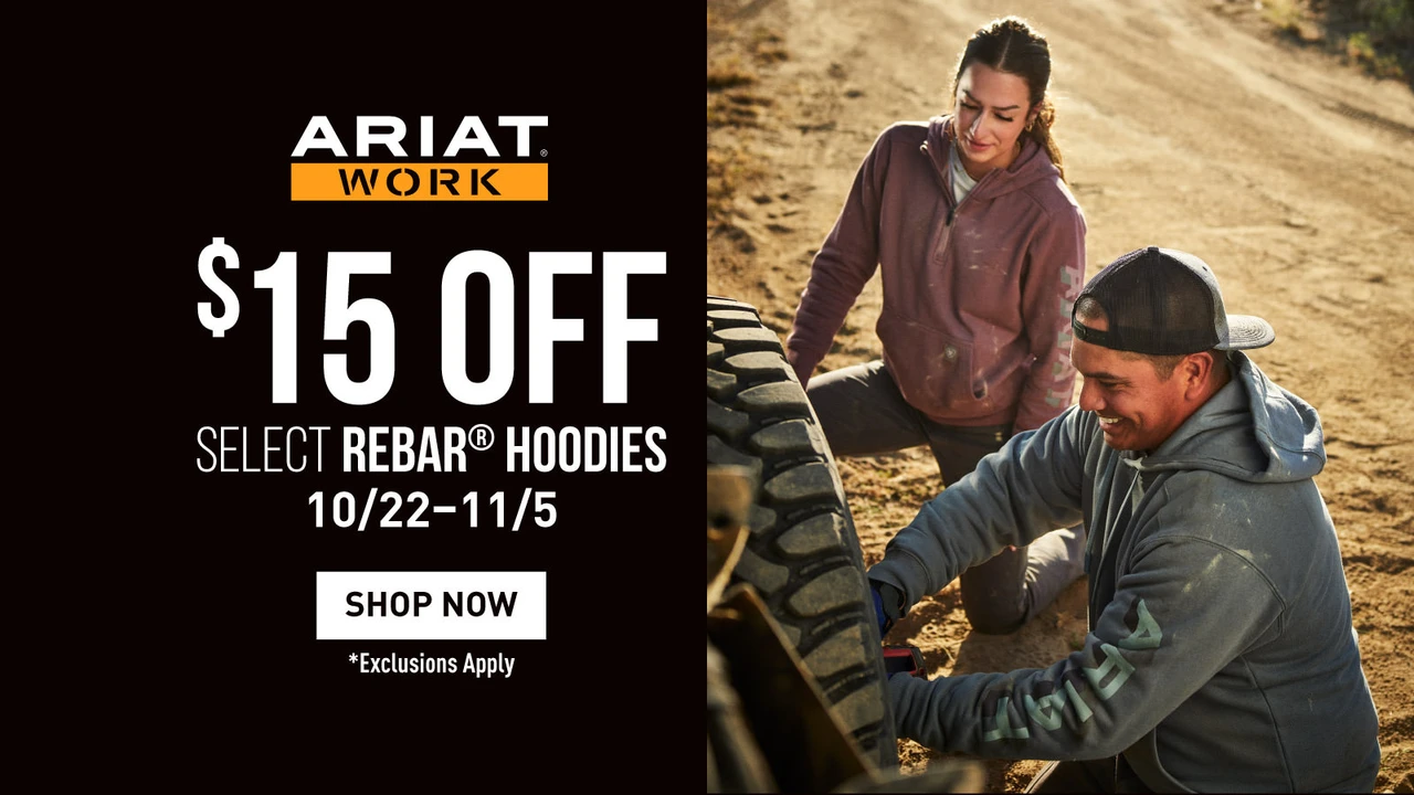Click here to shop Ariat Work: $15 off select Rebar hoodies, October 22 – November 5. Exclusions apply. Shown with two people in Ariat hoodies working on a truck tire outdoors.