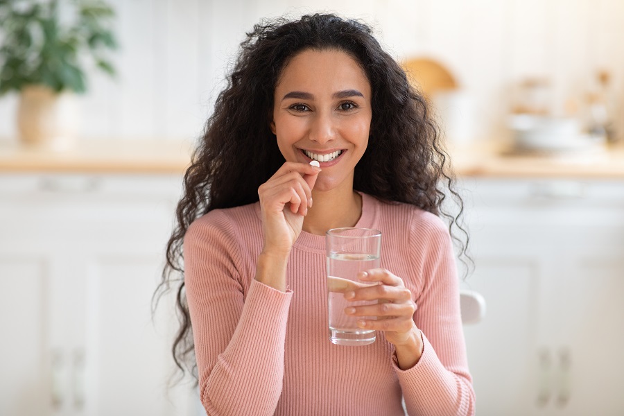 Woman Taking Supplements for Health