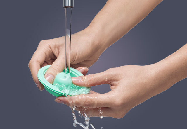 Woman cleaning a part of her Elvie Pump