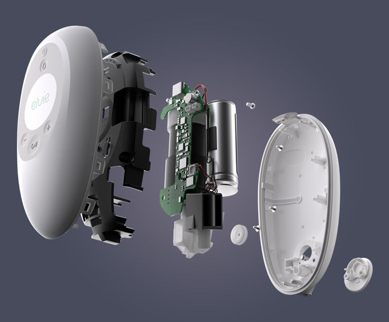 An Elvie Stride control panel, exploded open so the inner components can be seen. A motor and circuit board is seen between the front and back outer casing