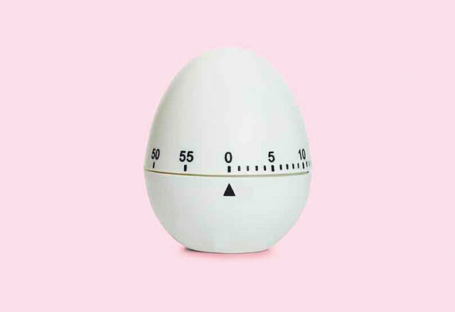 An egg timer on a pink background