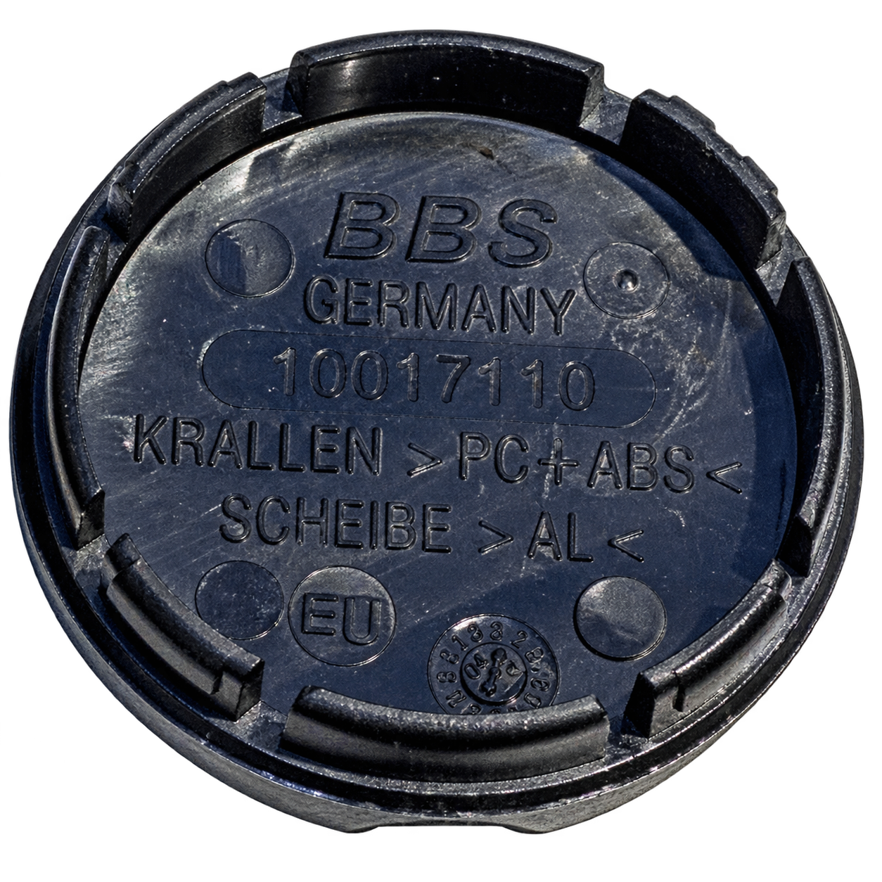 Backside of a BBS Type A center cap showing four retention tabs